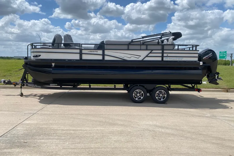 The Image of 2026 Ranger 223FC pontoon boat on trailer under cloudy sky. - 1