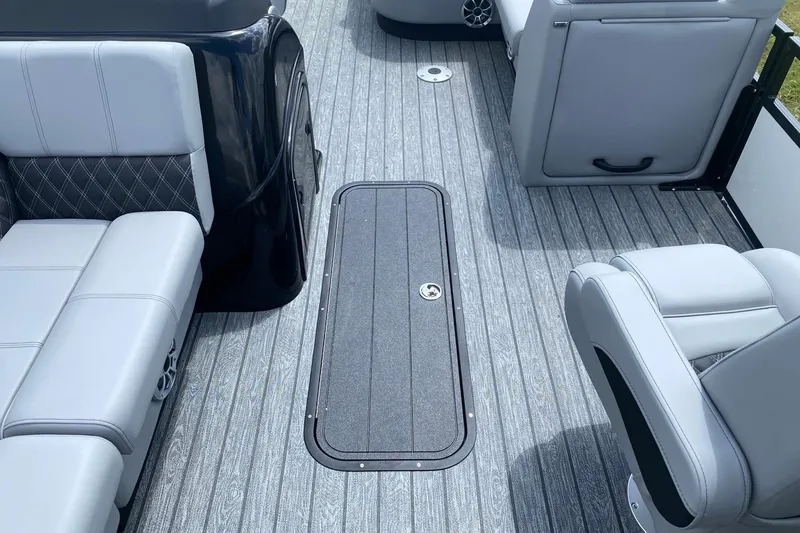 Slide: The Image of Luxurious seating with storage on 2026 Ranger 223FC boat, featuring tan and black upholstery. - 12
