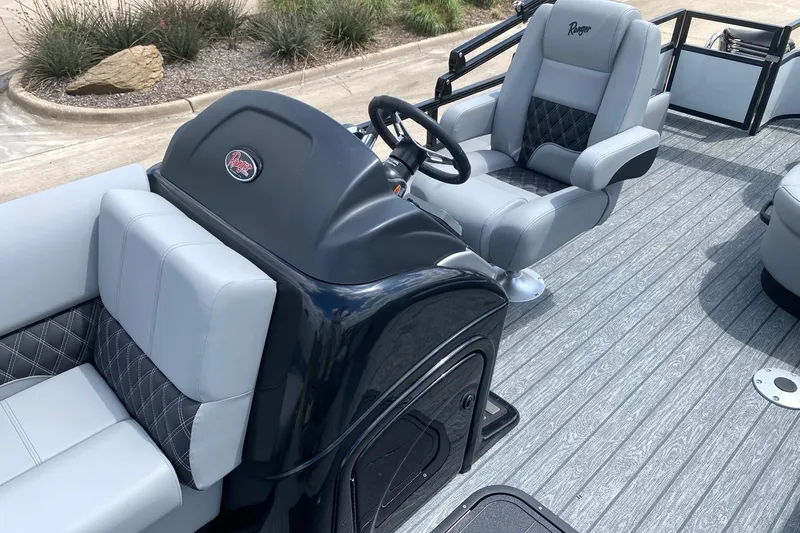 Slide: The Image of 2026 Ranger 223FC boat interior with plush seating and modern steering console. - 14