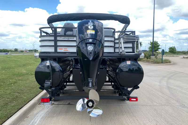 Slide: The Image of 2026 Ranger 223FC boat with powerful outboard motor, parked on a sunny day. - 18