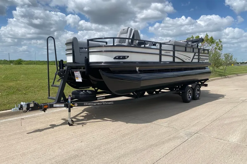 Slide: The Image of 2026 Ranger 223FC pontoon boat with red and black design, tan seating, and canopy. - 2