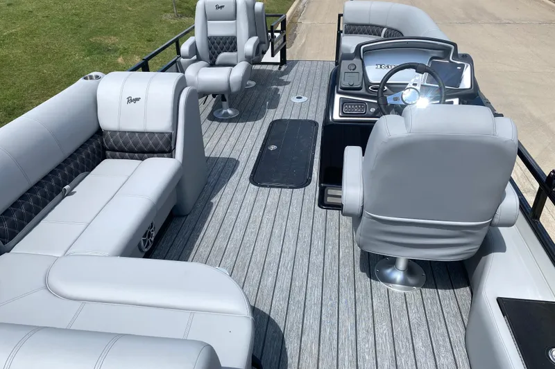 Slide: The Image of 2026 Ranger 223FC boat interior with gray seating and steering console. - 6