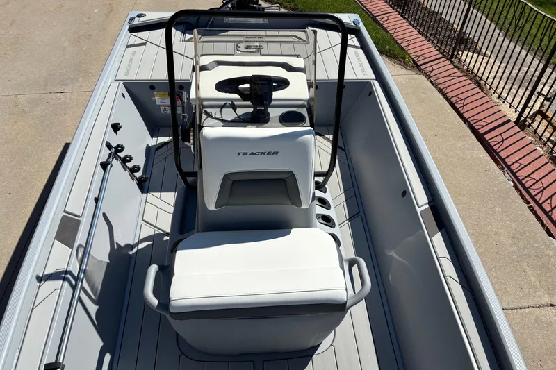 Slide: The Image of 2026 Tracker Bass Tracker Classic CC boat interior with steering console and seating. - 6