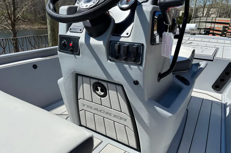 Slide: The Image of 2026 Tracker Bass Tracker Classic CC boat console with steering wheel and controls. - 7