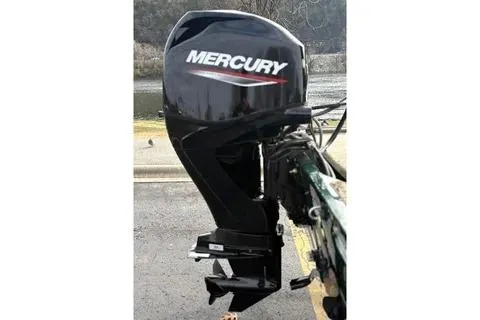 Slide: The Image of 2026 Tracker Bass Tracker Classic Limited with Mercury outboard motor on a trailer. - 13