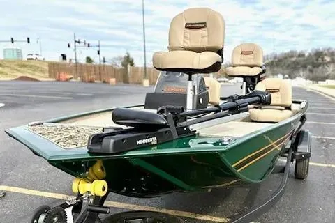 Slide: The Image of 2026 Tracker Bass Tracker Classic Limited boat with seating, parked outdoors. - 5