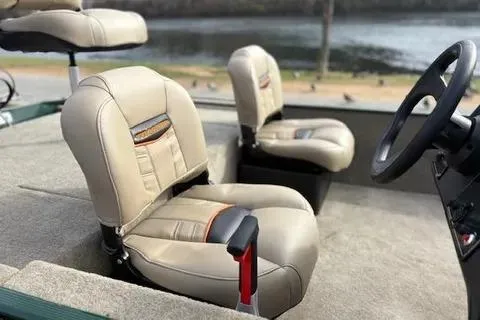 Slide: The Image of 2026 Tracker Bass Tracker Classic Limited boat seats, beige upholstery, near water. - 7