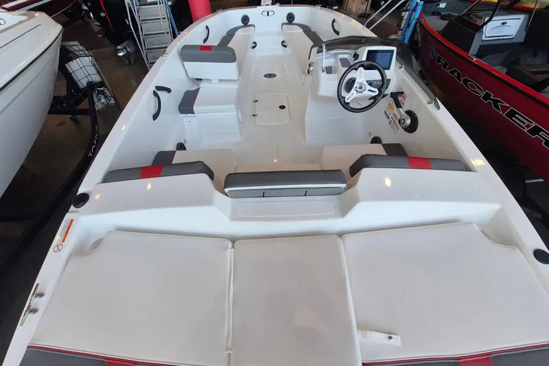 Slide: The Image of 2026 Tahoe T18 boat interior with seating, steering wheel, and control panel in showroom. - 8