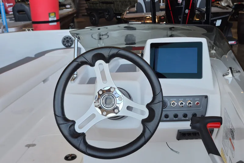 Slide: The Image of 2026 Tahoe T18 boat dashboard with steering wheel and touchscreen display. - 9