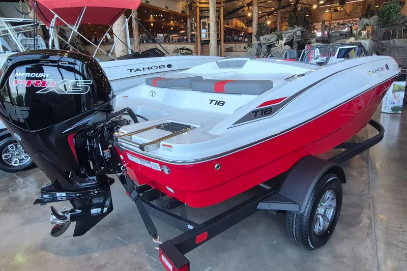 Slide: The Image of 2026 Tahoe T18 boat with Mercury Pro XS engine, displayed indoors on a trailer. - 7