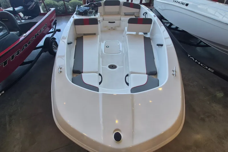 Slide: The Image of 2026 Tahoe T18 boat interior with seating and storage, displayed in a showroom. - 10