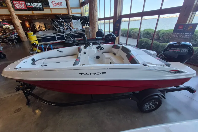 Slide: The Image of 2026 Tahoe T18 boat displayed indoors, featuring a sleek red and white design. - 4