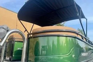 Slide: The Image of 2026 Regency 230 DL pontoon boat with luxurious tan seating and modern design. - 10