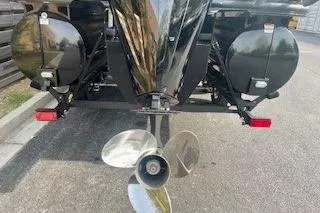 Slide: The Image of Rear view of 2026 Regency 230 DL boat with visible propeller and pontoons. - 11