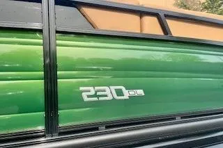 Slide: The Image of Top view of 2026 Regency 230 DL pontoon boat with tan seating and modern design. - 4