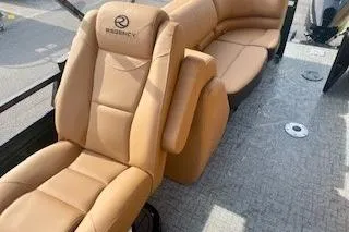 Slide: The Image of Luxurious seating in 2026 Regency 230 DL boat, featuring tan leather upholstery. - 7