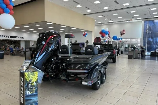 Slide: The Image of 2026 Nitro Z21 XL boat displayed in a showroom with festive balloons. - 1
