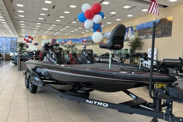 The Image of 2026 Nitro Z21 XL boat displayed in showroom with festive balloons. - 0