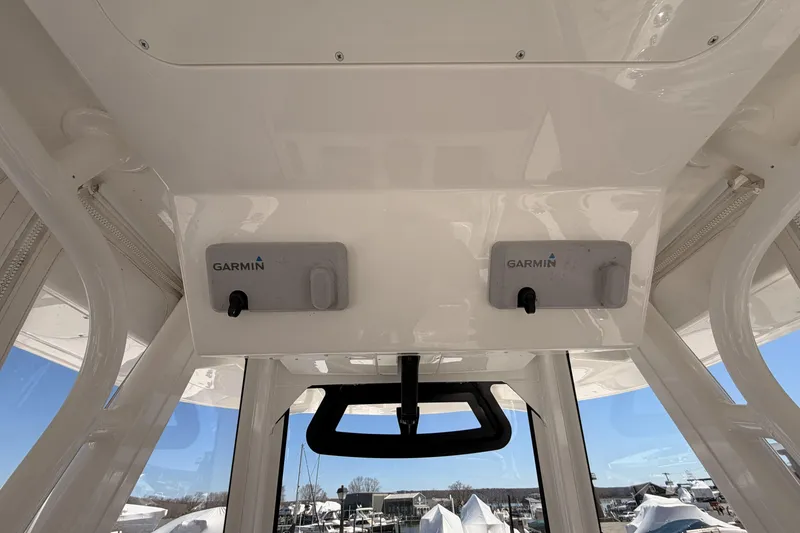 Slide: The Image of 2022 Regulator 28 Forward Seating boat with Garmin radar and FLIR camera, docked near houses. - 11