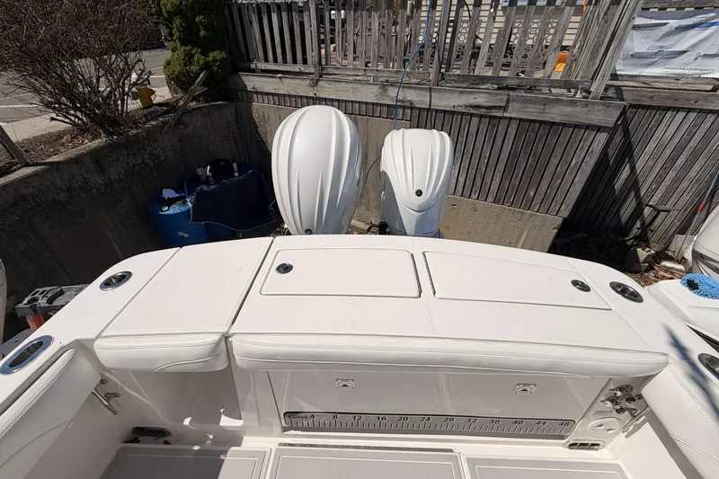 Slide: The Image of 2022 Regulator 28 Forward Seating boat at marina, showcasing spacious deck layout. - 16