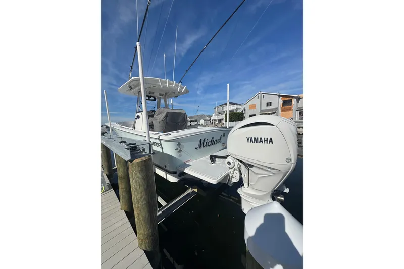Slide: The Image of 2022 Regulator 28 Forward Seating boat docked with Yamaha engine. - 2