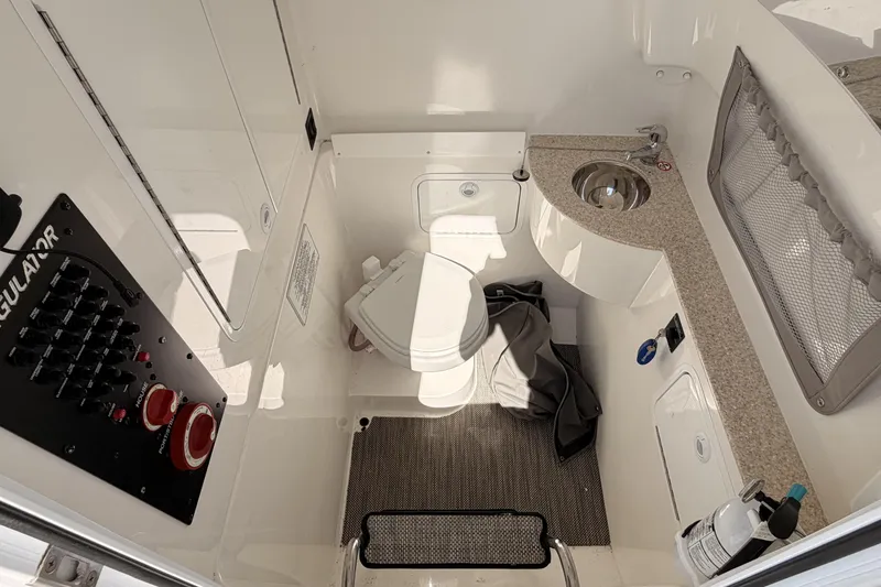 Slide: The Image of Interior of 2022 Regulator 28 Forward Seating with toilet and sink. - 20