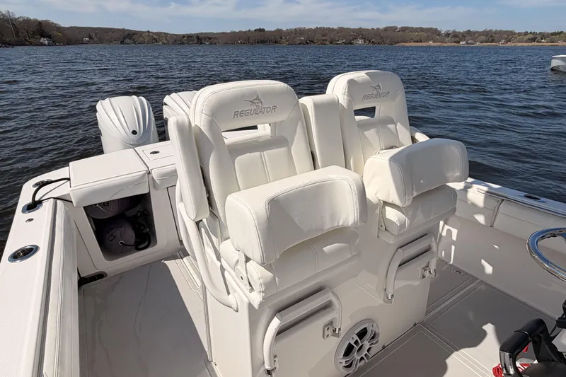 Slide: The Image of 2022 Regulator 28 boat with forward seating on the water. - 23