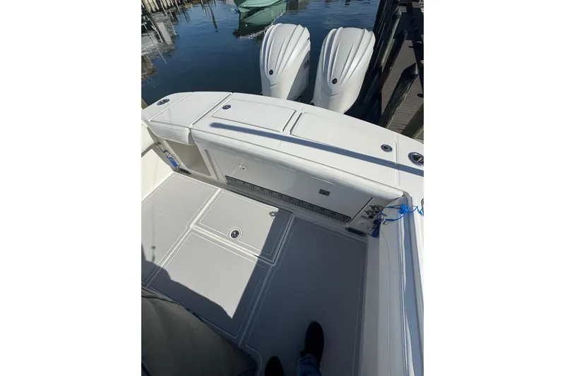 Slide: The Image of 2022 Regulator 28 Forward Seating boat with dual engines docked at marina. - 7