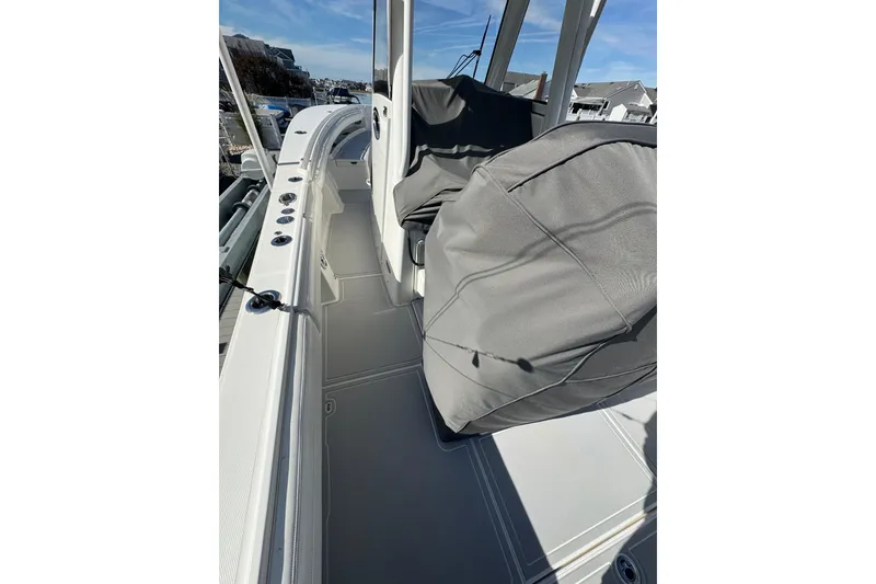 Slide: The Image of 2022 Regulator 28 Forward Seating boat interior with covered seats and sleek design. - 8