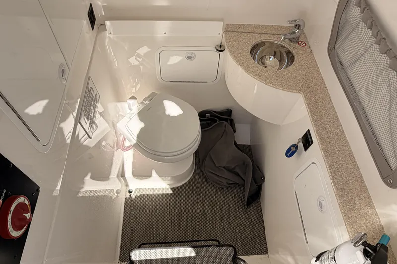 Slide: The Image of 2022 Regulator 28 Forward Seating boat interior with covered seats and sleek design. - 9