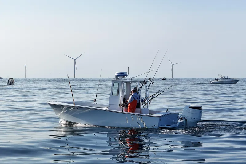The Image of 1975 SeaCraft SC 23 Classic boat on calm sea with wind turbines in background. - 0