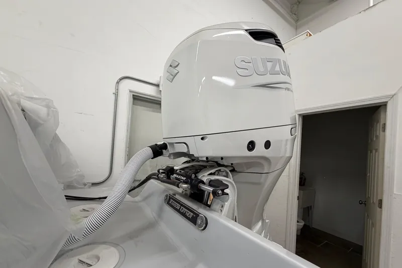 Slide: The Image of 1975 SeaCraft SC 23 Classic with Suzuki outboard motor in a garage setting. - 15