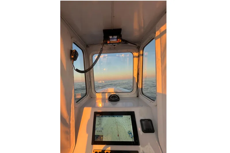 Slide: The Image of Interior view of 1975 SeaCraft SC 23 Classic boat with navigation equipment at sunset. - 18