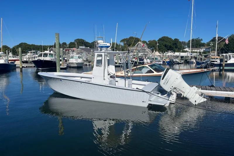 Slide: The Image of A 1975 SeaCraft SC 23 Classic boat docked in a marina under clear blue skies. - 2