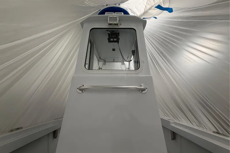 Slide: The Image of 1975 SeaCraft SC 23 Classic boat under protective cover, showcasing cabin and window. - 5