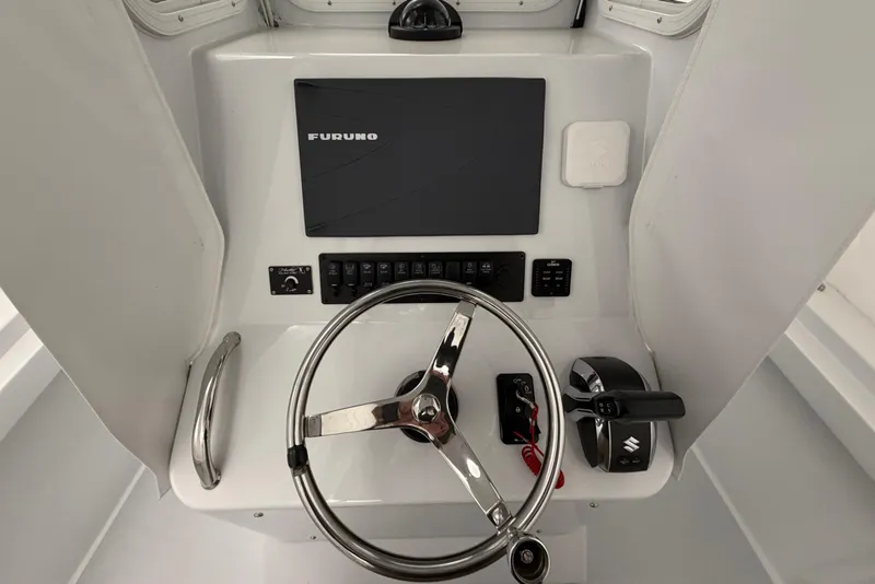 Slide: The Image of 1975 SeaCraft SC 23 Classic helm with Furuno navigation system and steering wheel. - 8