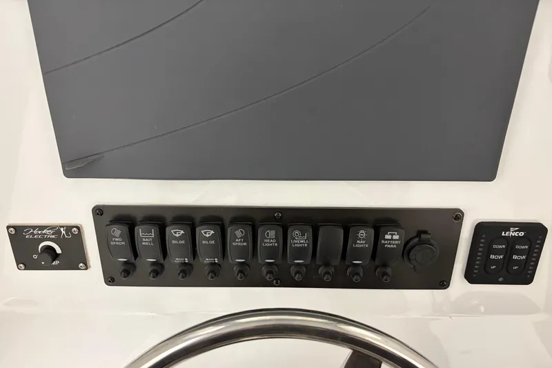 Slide: The Image of Control panel of a 1975 SeaCraft SC 23 Classic boat with various switches and dials. - 9