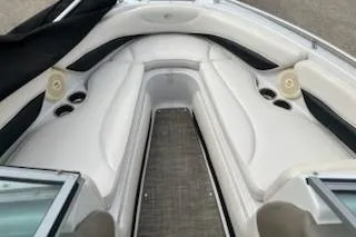 Slide: The Image of 2011 Crownline 21 SS boat interior with white seating and cup holders. - 11