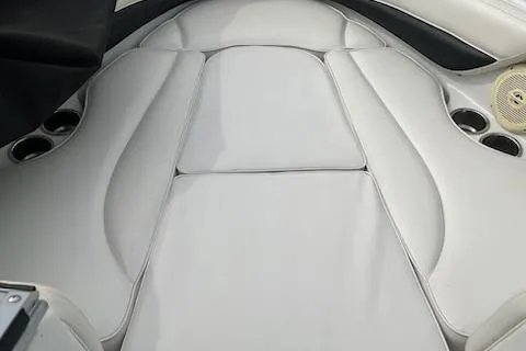 Slide: The Image of 2011 Crownline 21 SS boat interior with white cushioned seating and cup holders. - 4