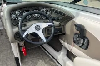 Slide: The Image of 2011 Crownline 21 SS boat dashboard with steering wheel and control panel. - 5