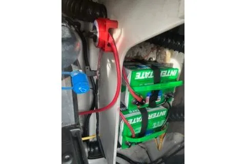 Slide: The Image of 2011 Crownline 21 SS boat battery compartment with Interstate batteries and wiring. - 8