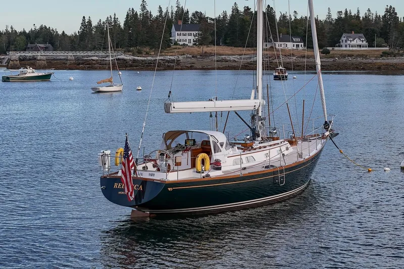 Slide: The Image of Sailboat Hinckley Sou'wester 51, 1989 model, anchored in scenic coastal waters. - 12