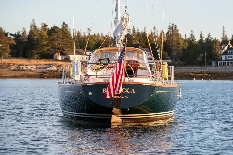 Slide: The Image of Hinckley Sou'wester 51 sailboat from 1989 on calm water, American flag displayed. - 16