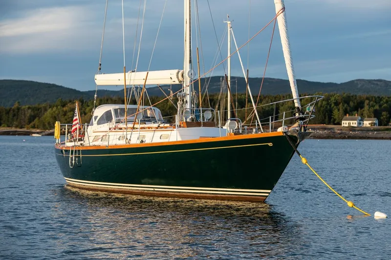 Slide: The Image of Sailboat Hinckley Sou'wester 51, 1989 model, anchored in scenic coastal waters. - 17