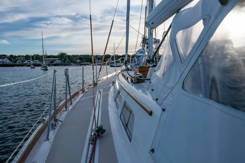 Slide: The Image of 1989 Hinckley Sou'wester 51 sailboat docked in a serene harbor setting. - 19