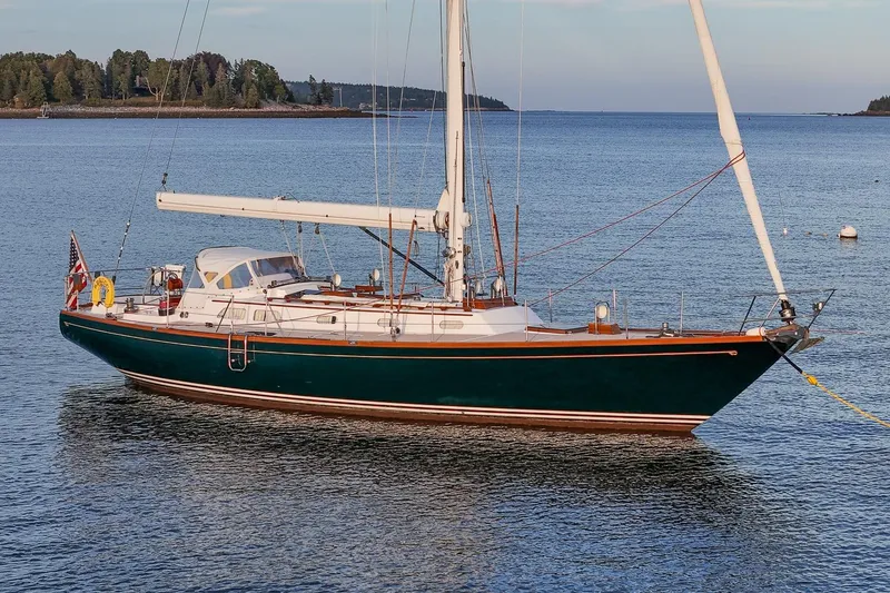 Slide: The Image of 1989 Hinckley Sou'wester 51 sailboat anchored in calm waters, showcasing elegant design. - 2