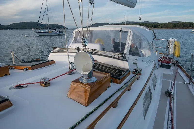 Slide: The Image of 1989 Hinckley Sou'wester 51 sailboat deck with scenic water and hills in background. - 21