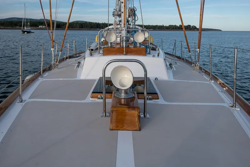 Slide: The Image of Hinckley Sou'wester 51 sailboat deck, 1989 model, on calm water with scenic background. - 22