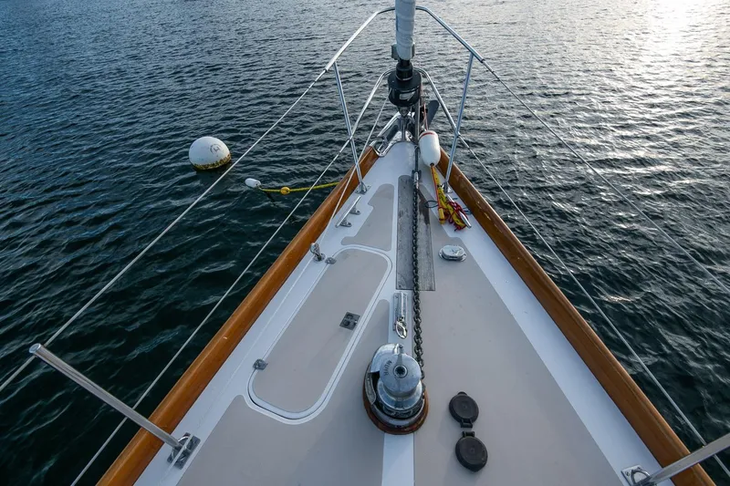 Slide: The Image of Bow view of 1989 Hinckley Sou'wester 51 sailboat on calm water. - 24