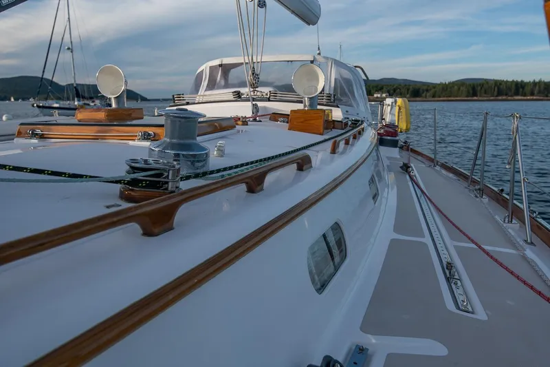Slide: The Image of Hinckley Sou'wester 51 sailboat deck, 1989 model, on calm waters with scenic background. - 26